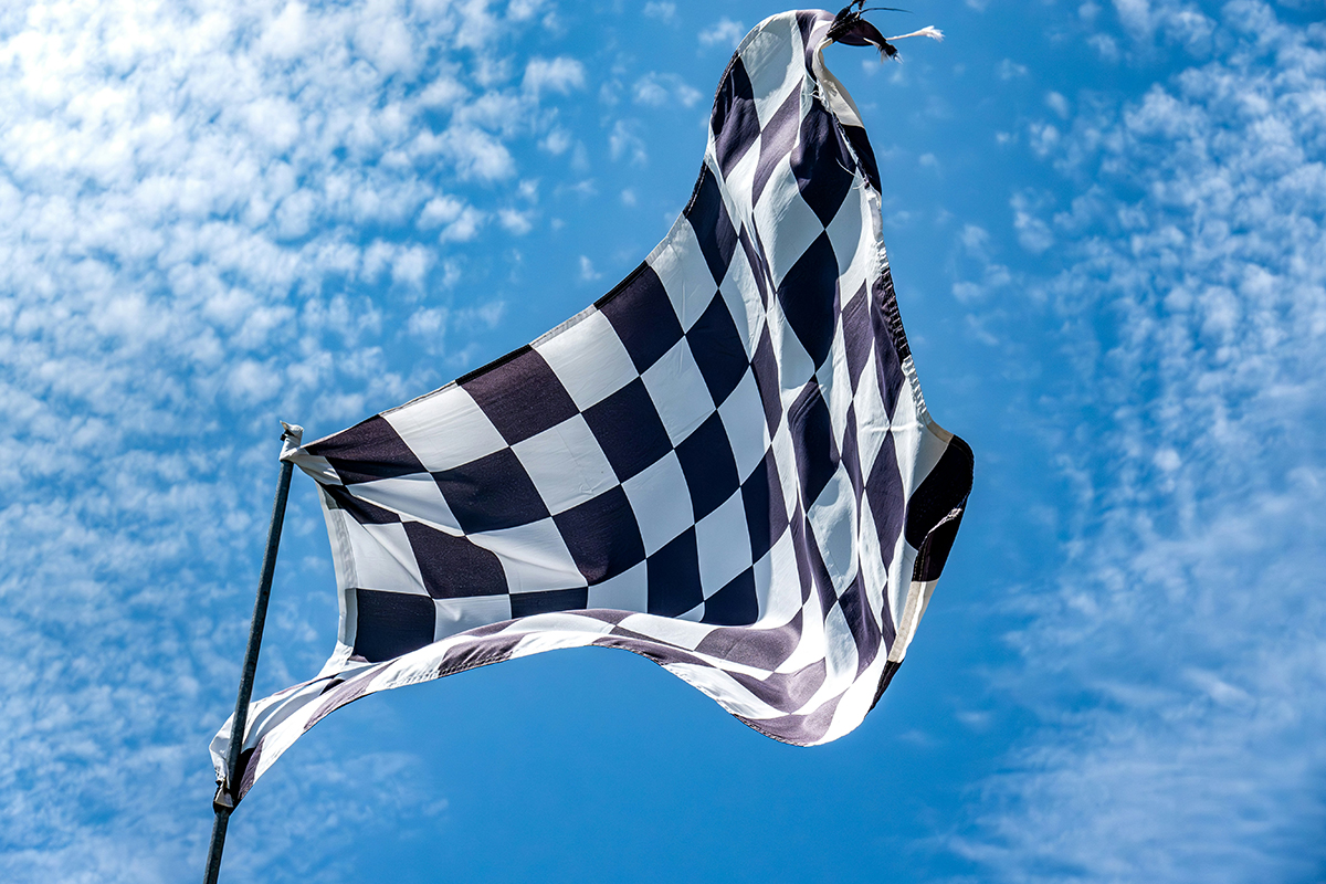 black and white checkered flag waving at the Indy 500